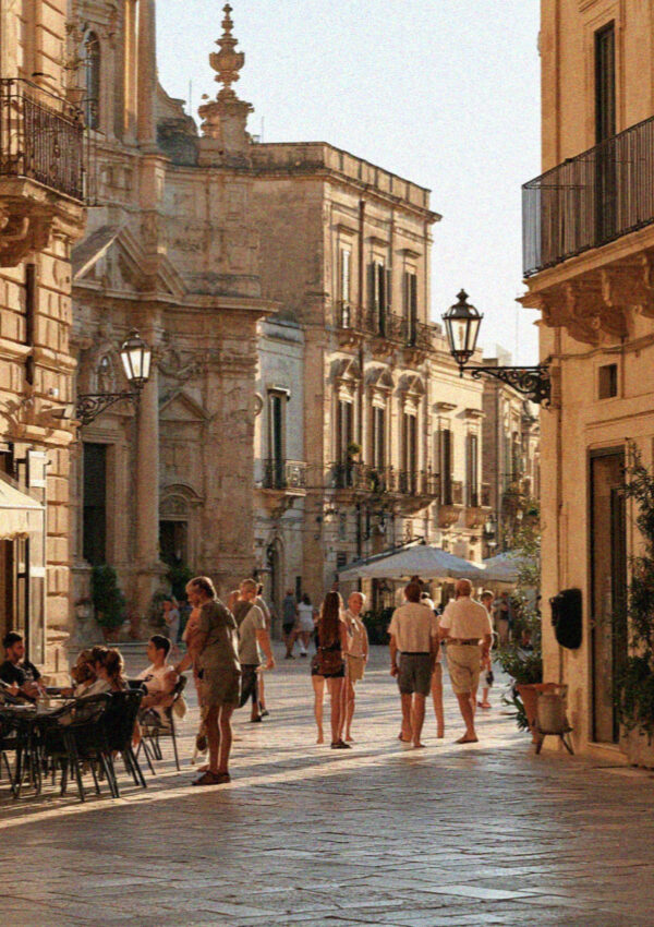 Local people out for the evening passeggiata in a baroque square in Lecce