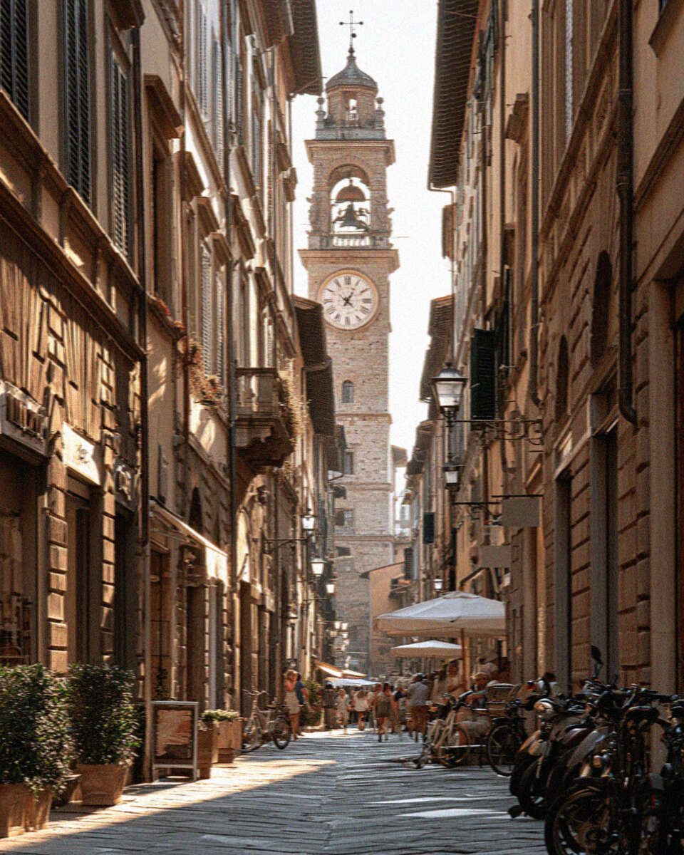 Via Fillungo, the medieval main street of Lucca, with old shopfronts and a tower