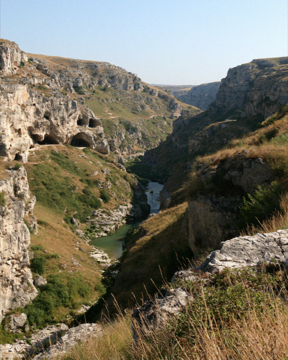 The Gravina ravine below Matera, its far wall pocked with cave mouths