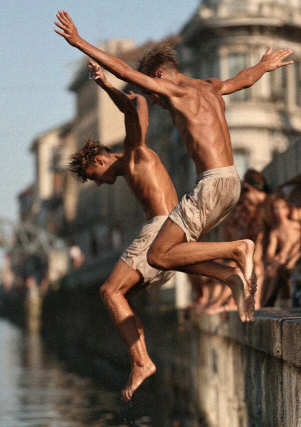 Boys jumping into a Milan canal on a hot evening