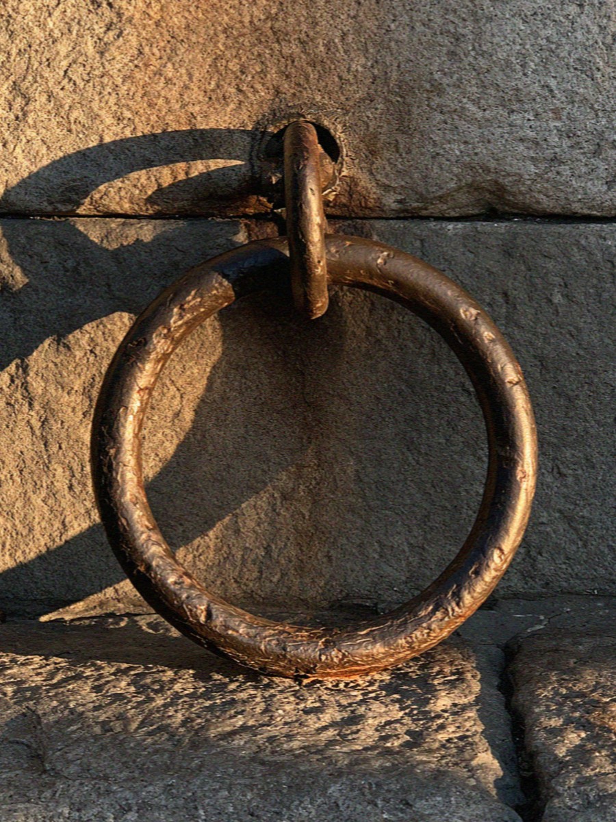 An old iron mooring ring set into canal stone in Milan