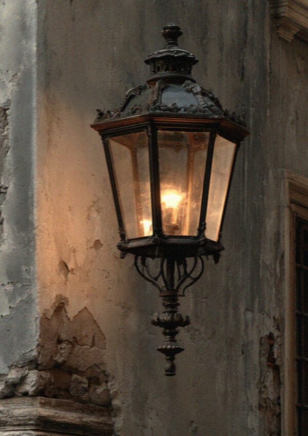 An old iron lamp on a Milan wall at dusk