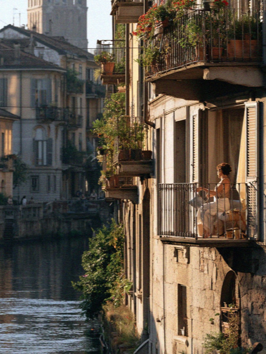 A Milan canal running between old buildings in the evening