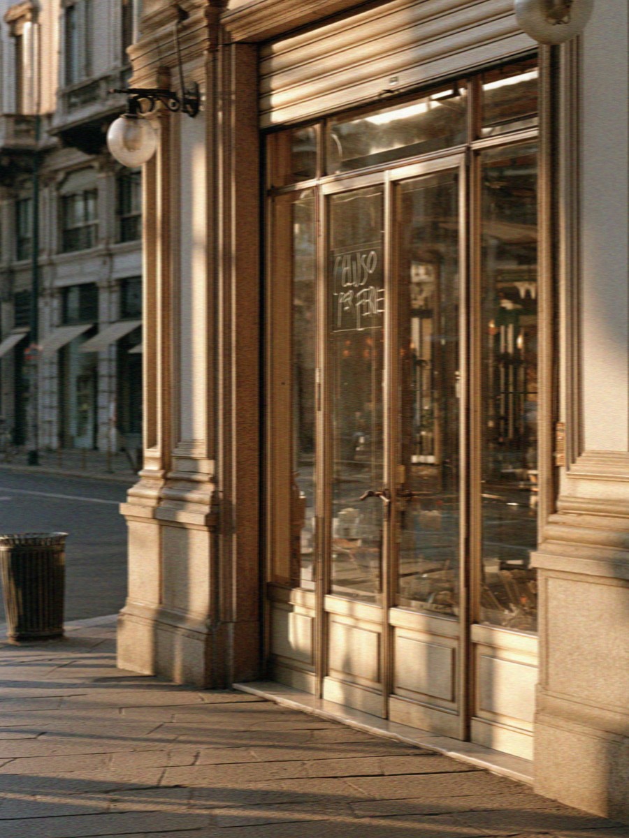 A lit Milan shopfront in the evening