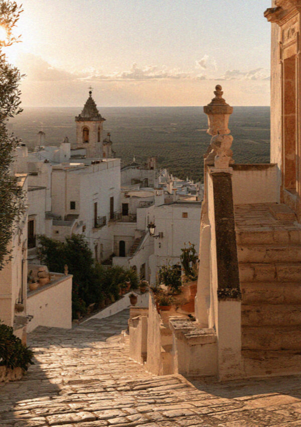 White rooftops and stone steps in the old town of Ostuni at dusk