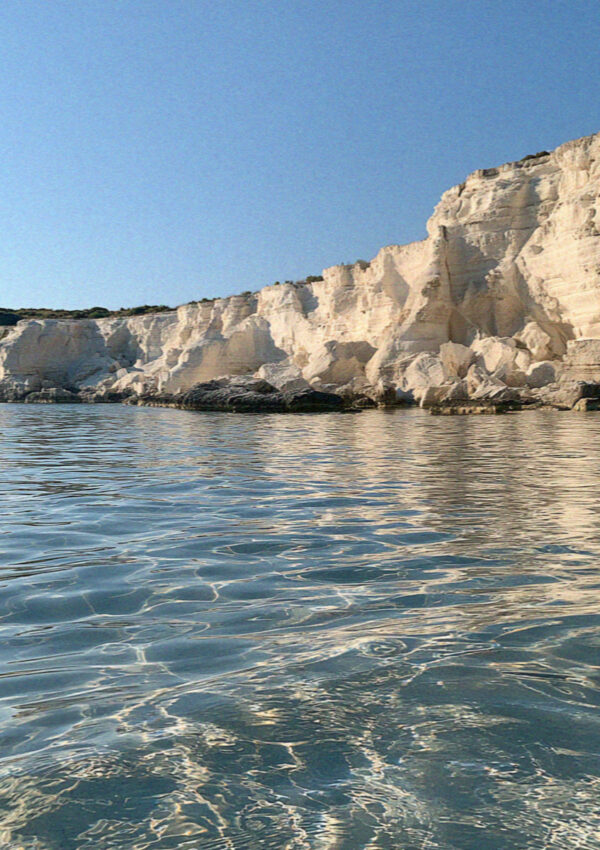 White limestone cliff above clear shallow water on the coast near Ostuni