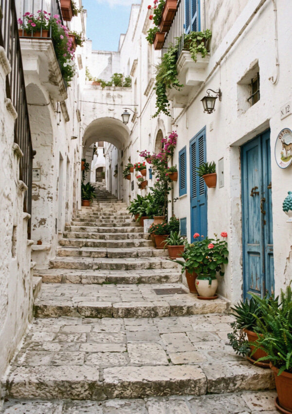 Worn stone steps climbing between whitewashed walls in the old town of Ostuni in Puglia