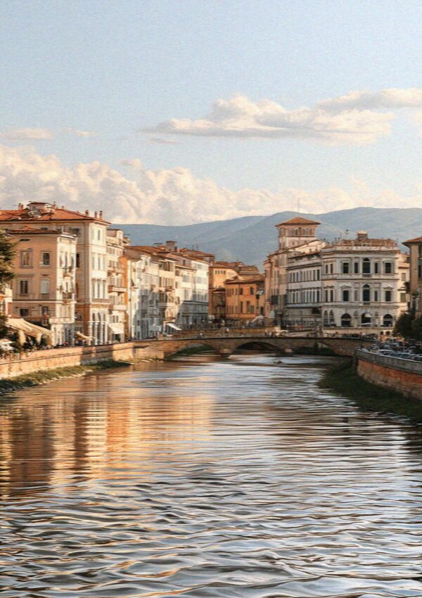 The Arno river through Pisa lined with pastel palazzi along the Lungarno