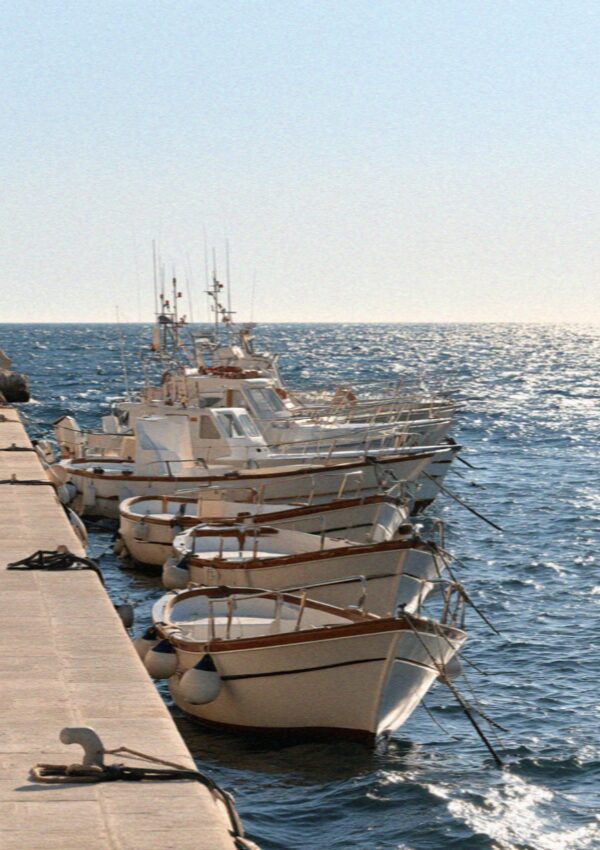 Tour boats tied up on their moorings near Polignano a Mare