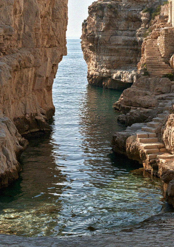 Turquoise water over the pebbles at Lama Monachile, Polignano a Mare