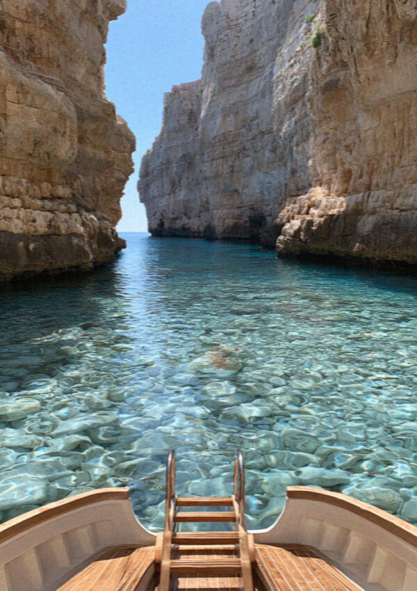 A boat ladder over clear deep water in a cove at Polignano a Mare