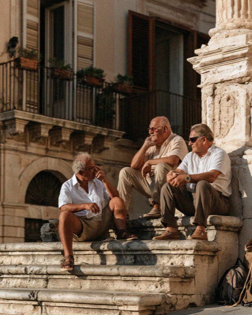 Locals talking on the steps of a square on Ortigia in Syracuse