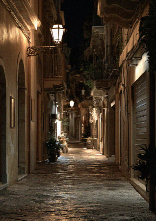 An empty lamplit lane in Taormina at midnight