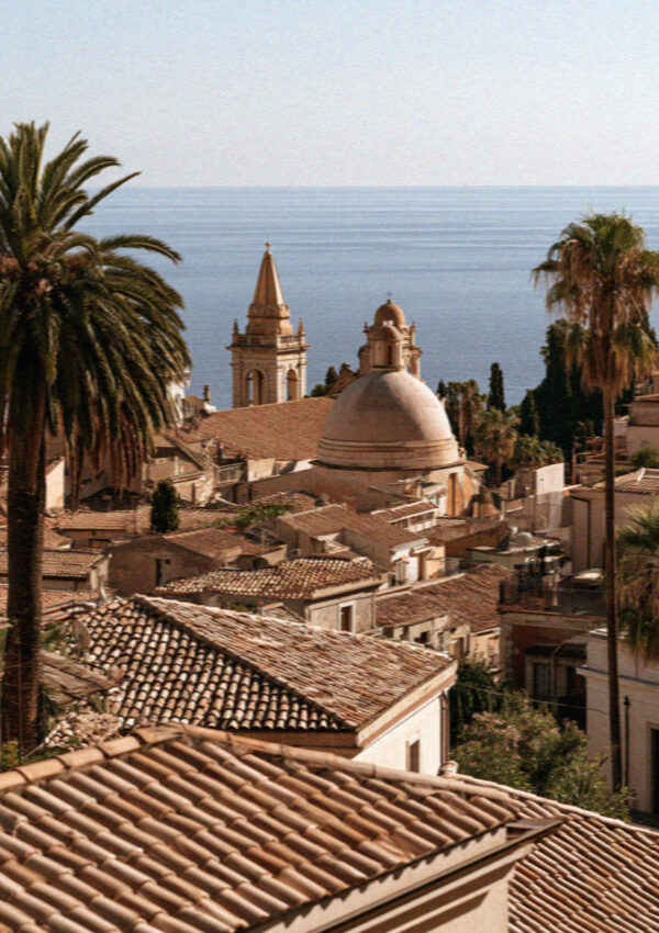 Terracotta rooftops of Taormina above the Ionian sea