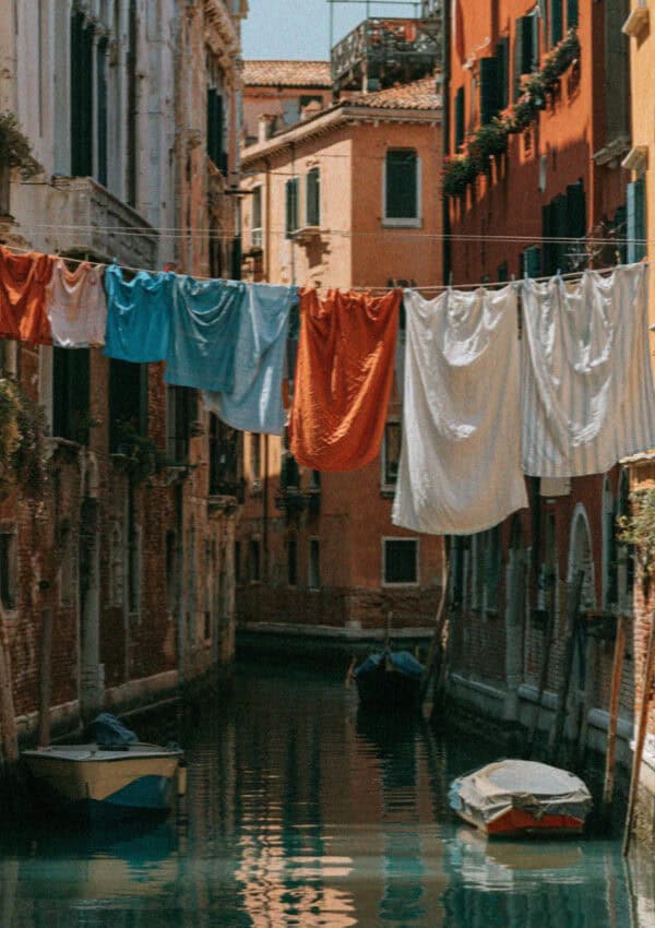 A narrow Venetian canal with washing strung overhead