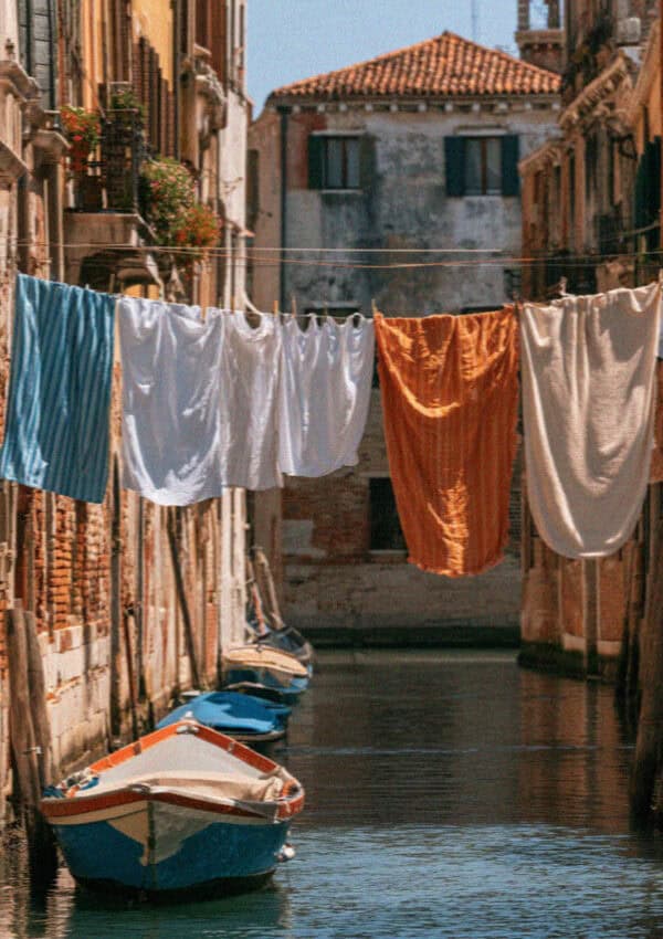 A quiet Venetian canal with laundry and a moored boat