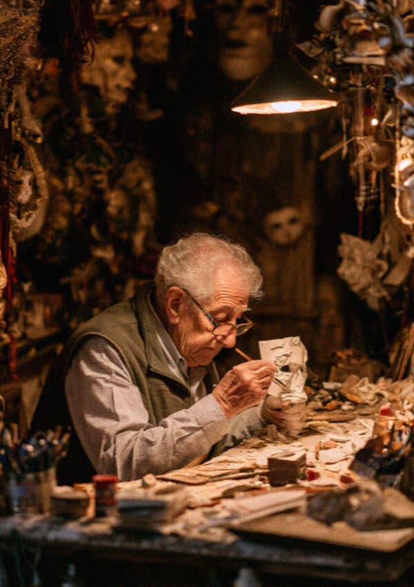 A Venetian mask-maker at his workbench