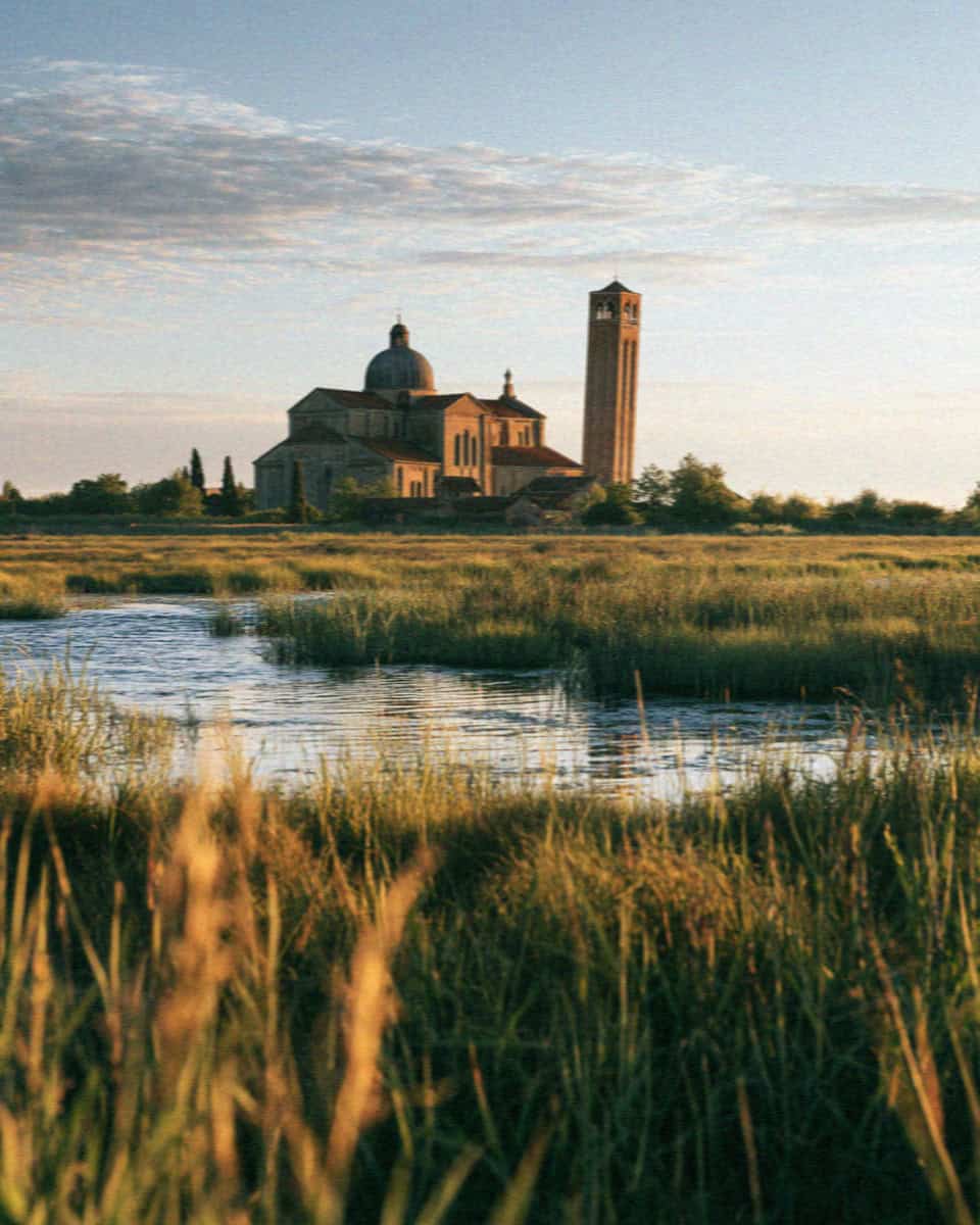 The cathedral and leaning campanile of Torcello across the lagoon