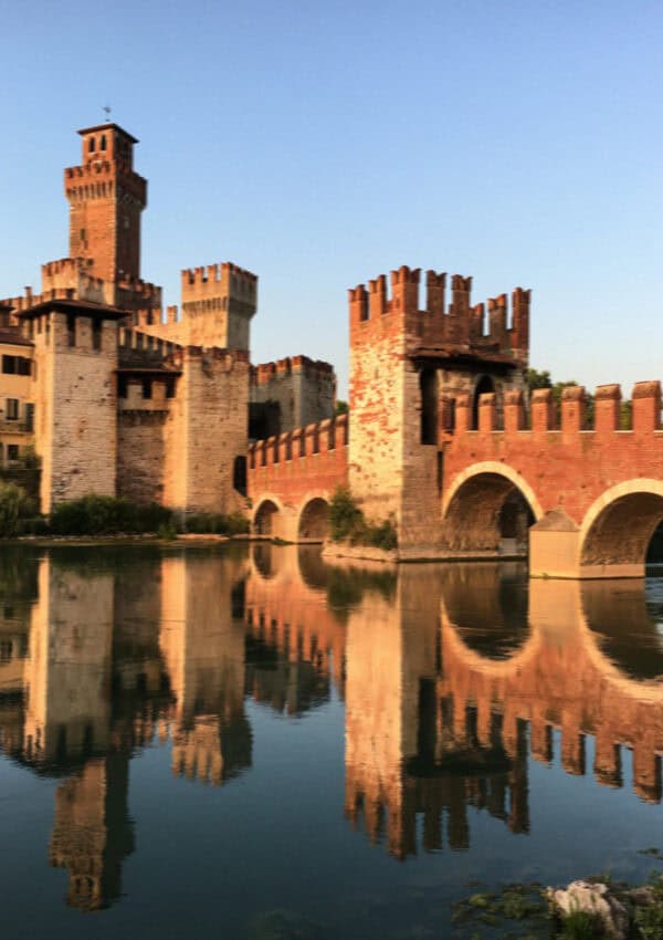 The Castelvecchio bridge reflected in the Adige at dusk, Verona