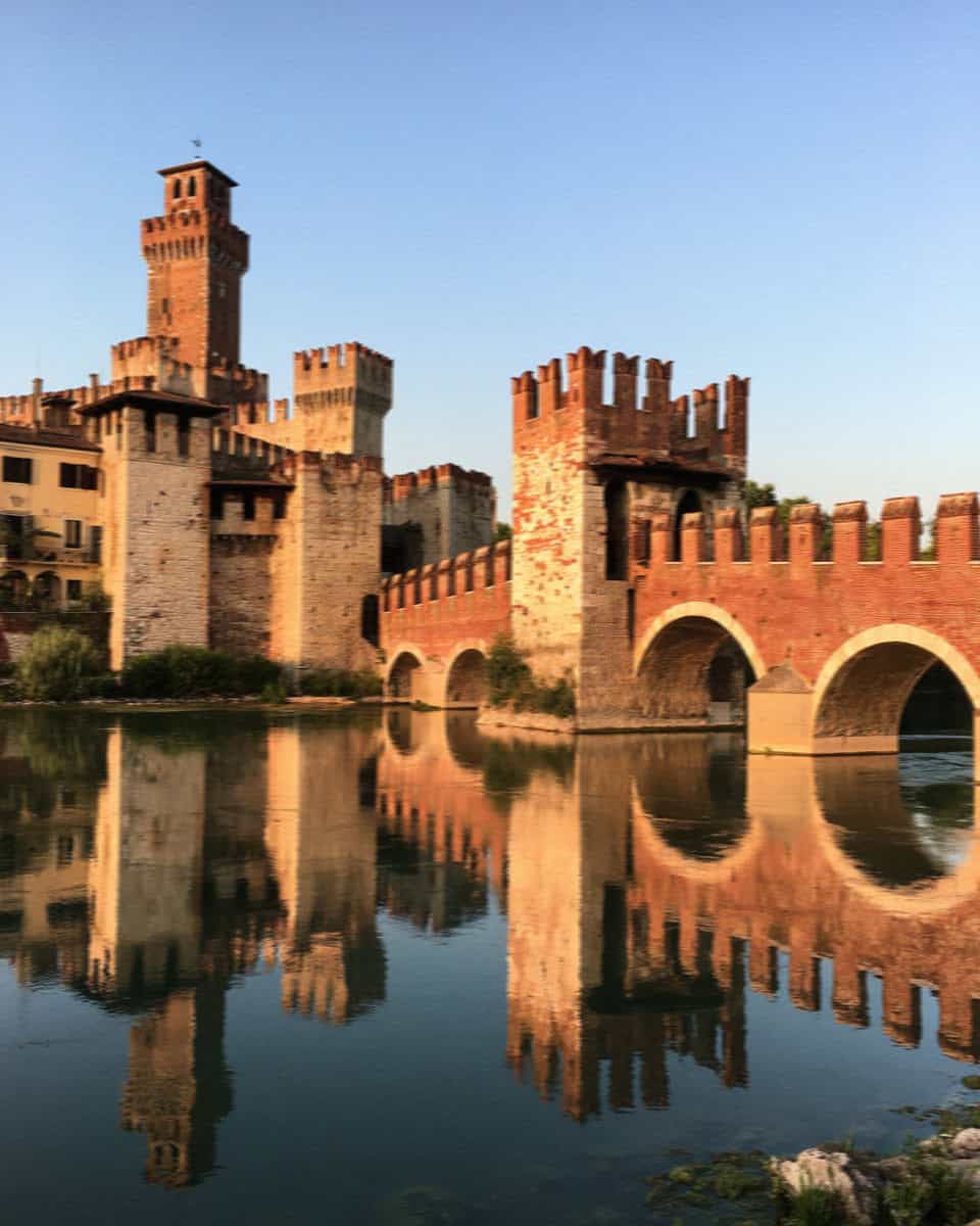 The Castelvecchio bridge reflected in the Adige at dusk, Verona