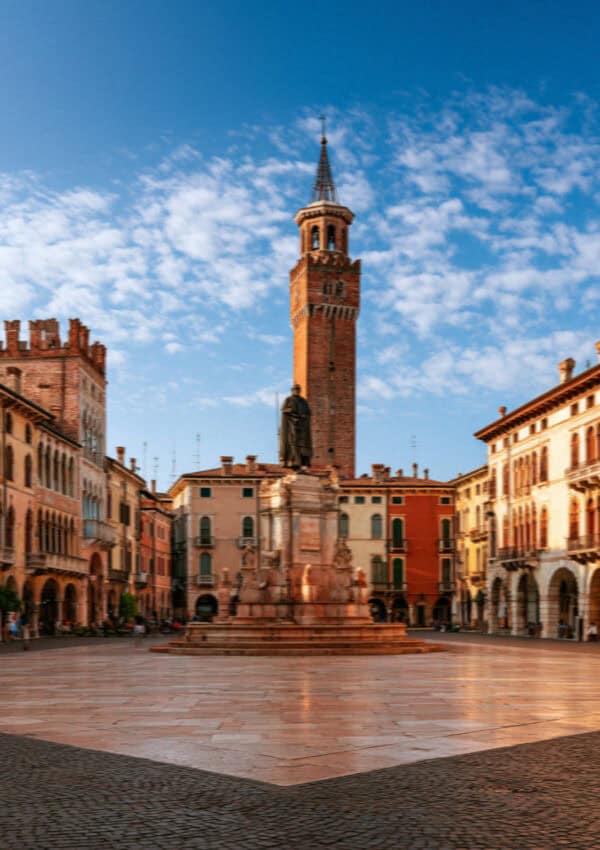 Piazza dei Signori and the Torre dei Lamberti under a blue sky, Verona