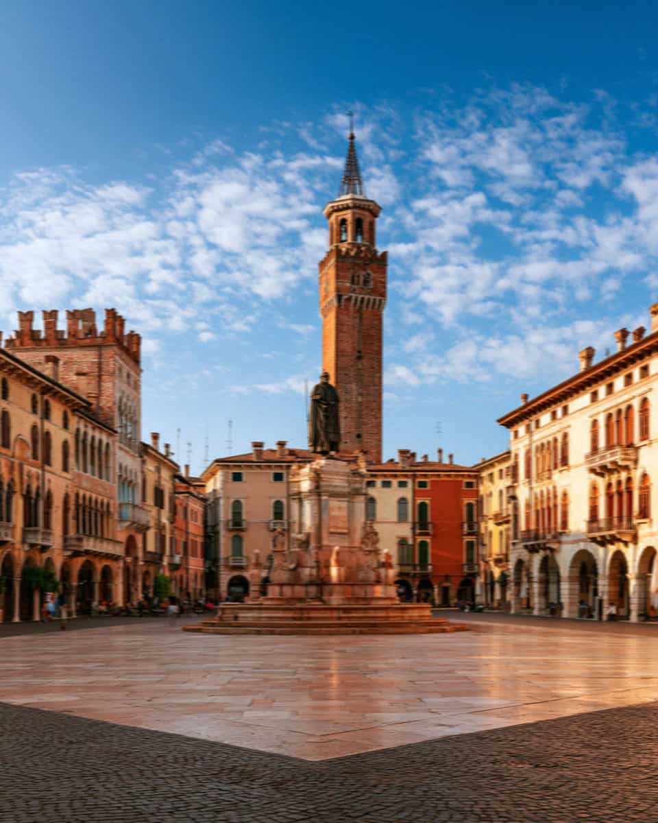 Piazza dei Signori and the Torre dei Lamberti under a blue sky, Verona