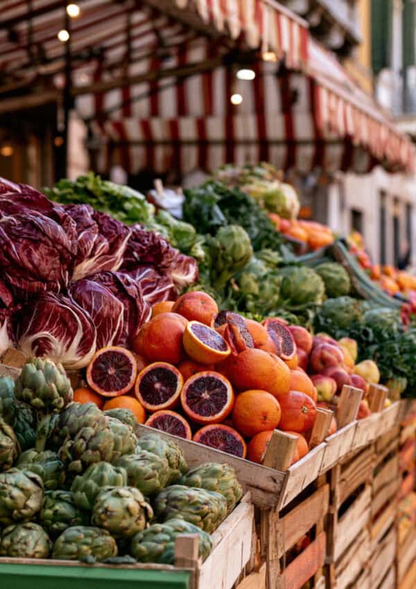 A produce stall of radicchio, artichokes and blood oranges at the Piazza delle Erbe market, Verona