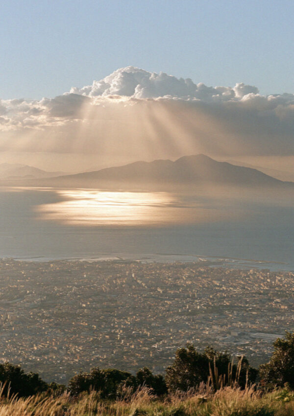 The whole Bay of Naples seen hazy from high on the slope of Vesuvius, the city and the sea below, no people