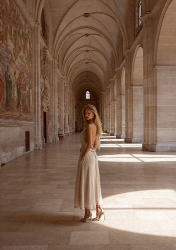 Victoria van der Berg alone in the tall frescoed nave of the Upper Basilica in Assisi in full morning daylight