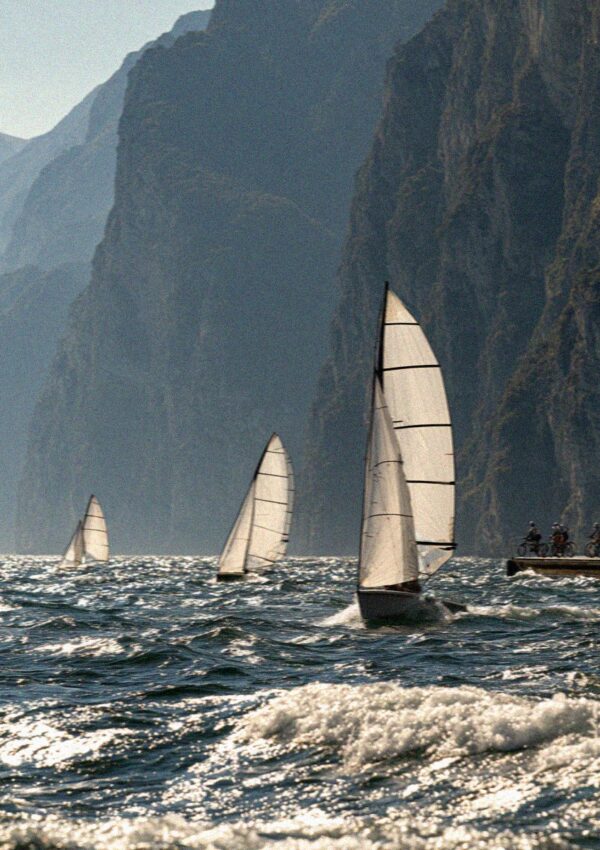 Sailing boats racing on windy northern Lake Garda