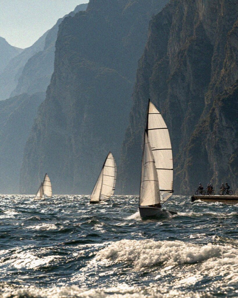Sailing boats racing on windy northern Lake Garda