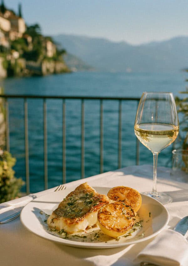 Lake fish and pale wine on the terrace over Lake Maggiore