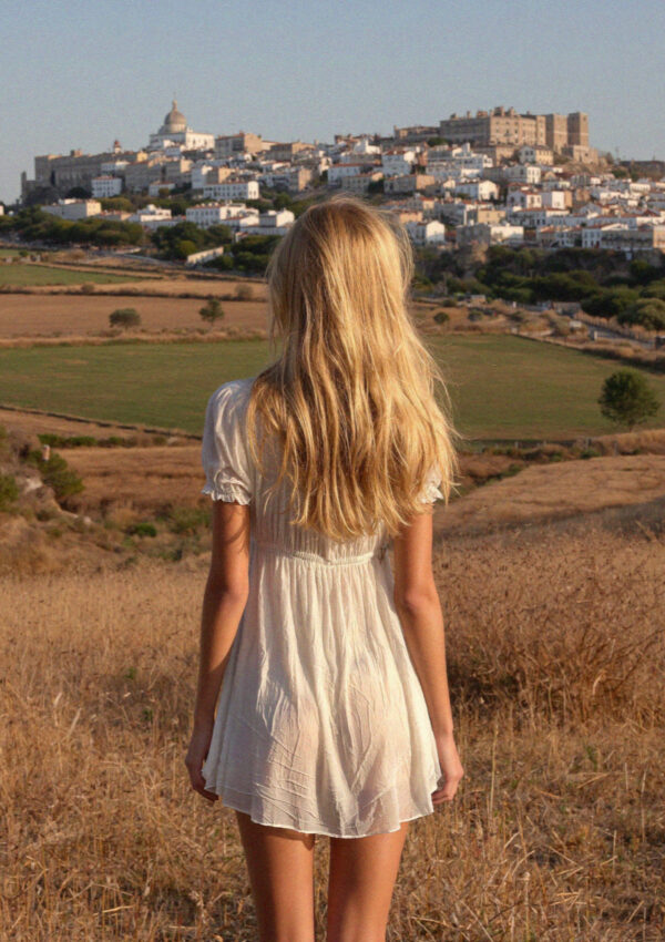 Victoria van der Berg in the fields below Ostuni looking up at the white hill town