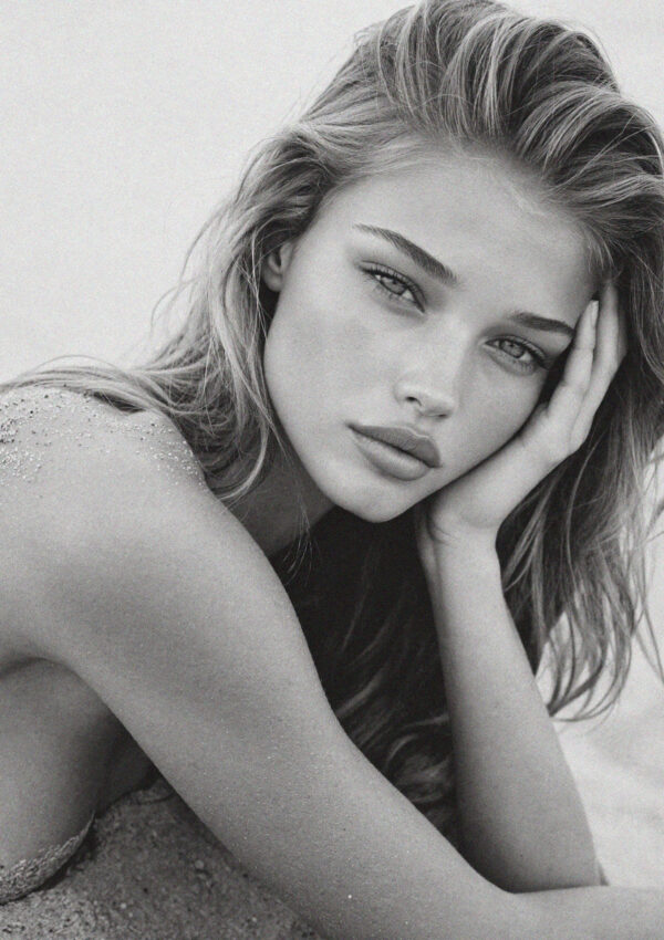 Victoria van der Berg resting on the sand on the Salento coast near Lecce, black and white