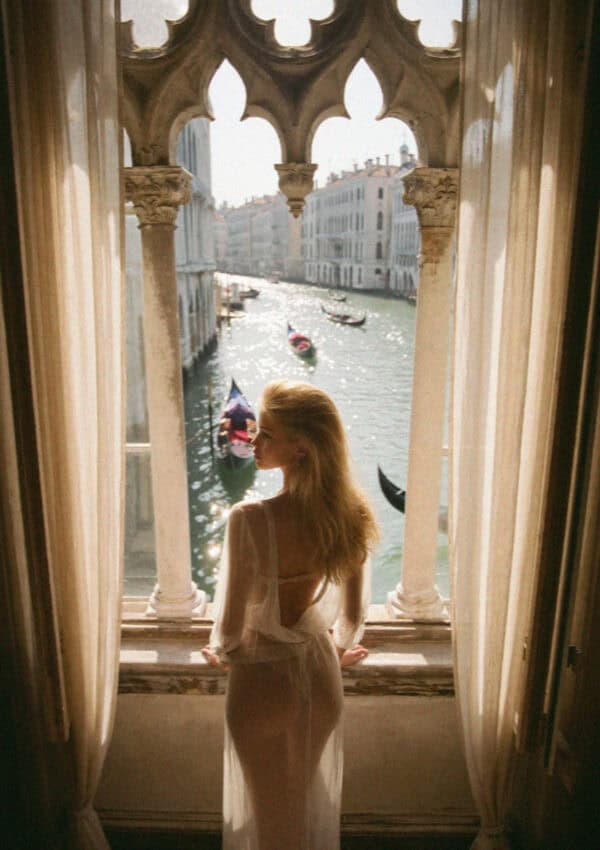 Victoria van der Berg at a Gothic palazzo window over the Grand Canal in Venice