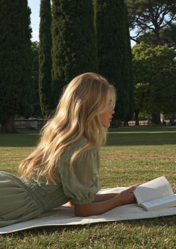 Victoria Van Der Berg reading on the lawn of the Giardino Giusti in Verona