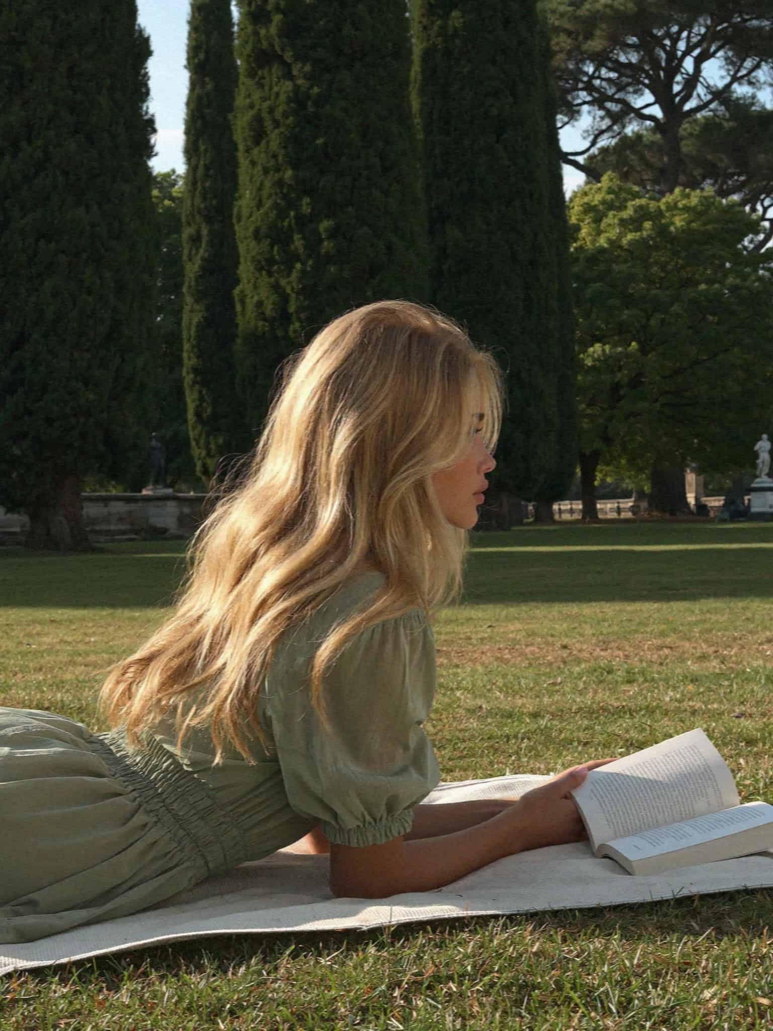 Victoria Van Der Berg reading on the lawn of the Giardino Giusti in Verona