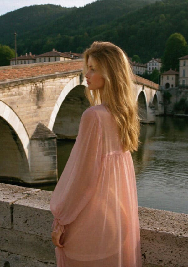 Victoria in a pink dress on Ponte Pietra above the Adige, Verona