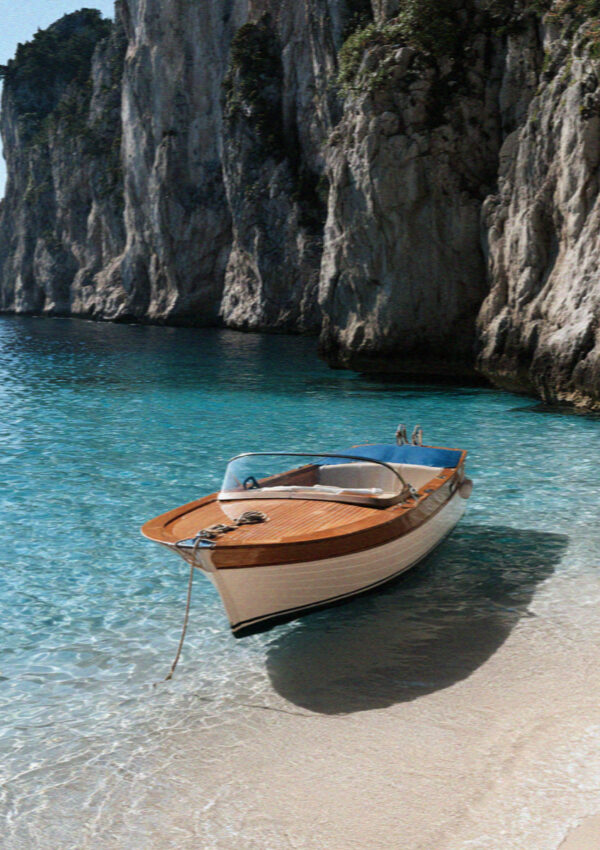 A traditional wooden gozzo at anchor in turquoise water below the cliffs of Capri