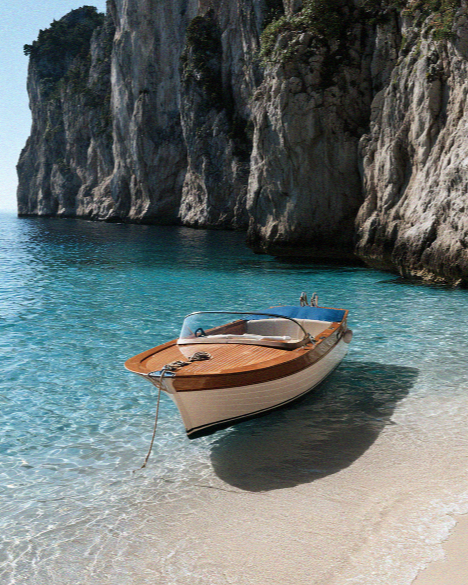 A traditional wooden gozzo at anchor in turquoise water below the cliffs of Capri