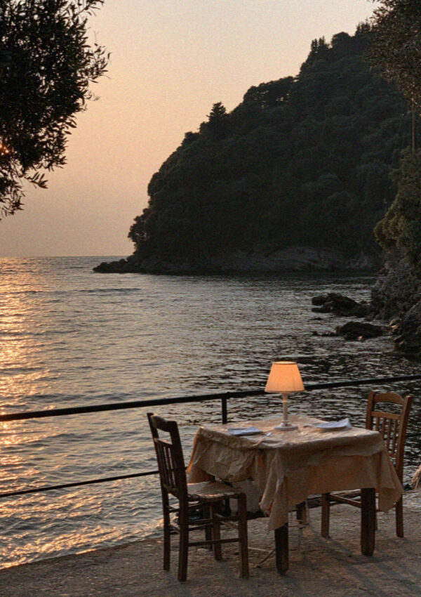 A taverna table set above the bay in Corfu as the light goes