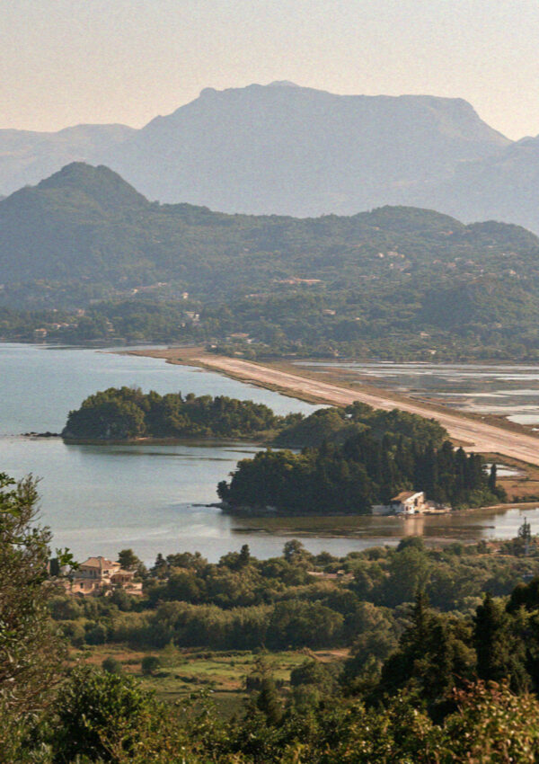 The lagoon in Corfu with the runway on its strip of made ground and the small monastery island beyond