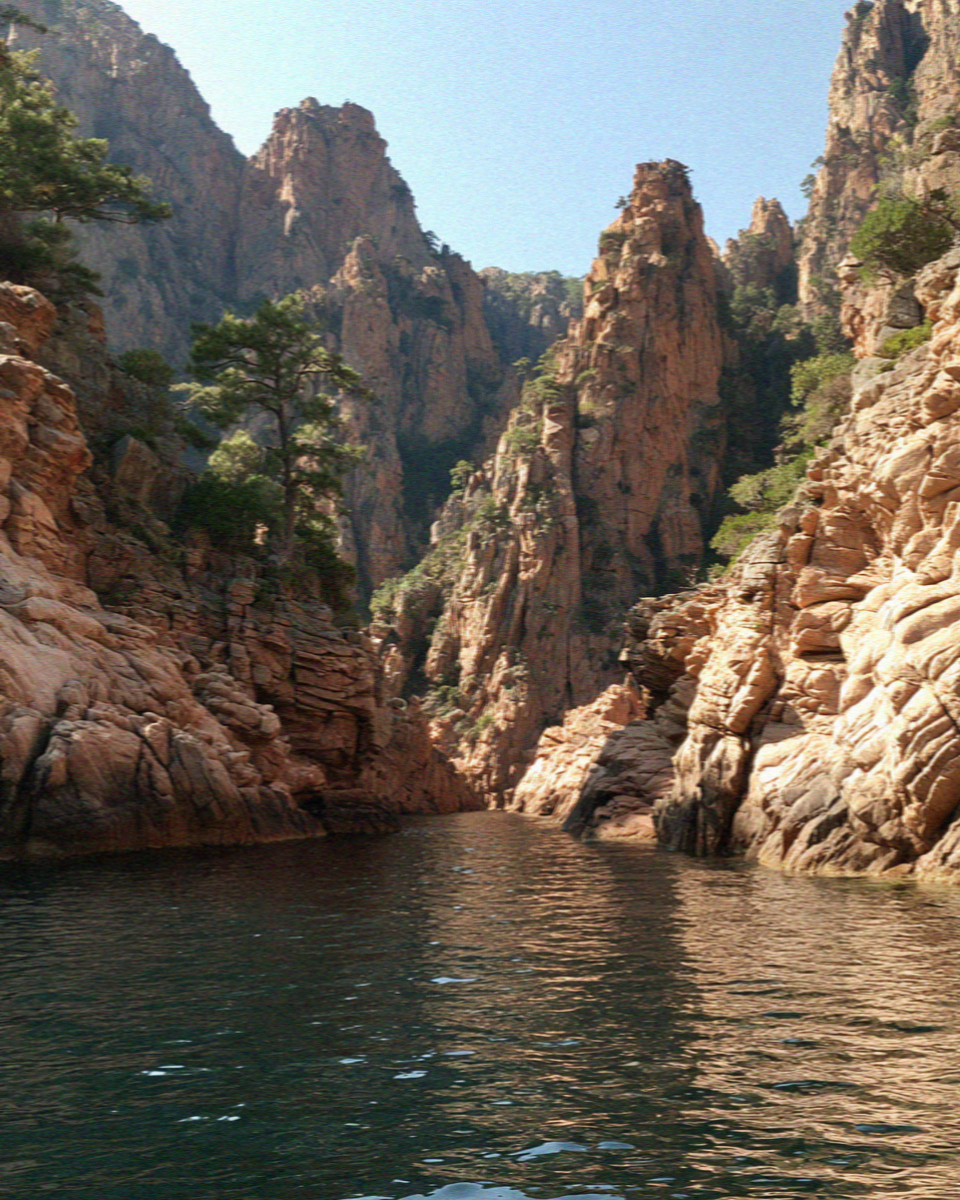 Red granite rock formations above an inlet on the Corsican coast