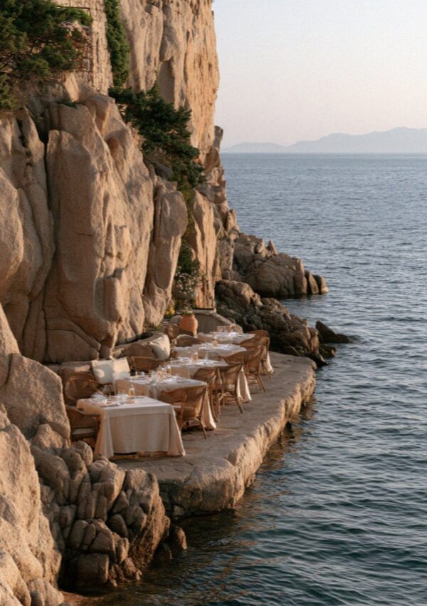 The terrace bar cut into the rocks above the sea on the Costa Smeralda in Sardinia