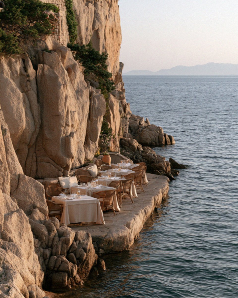 The terrace bar cut into the rocks above the sea on the Costa Smeralda in Sardinia