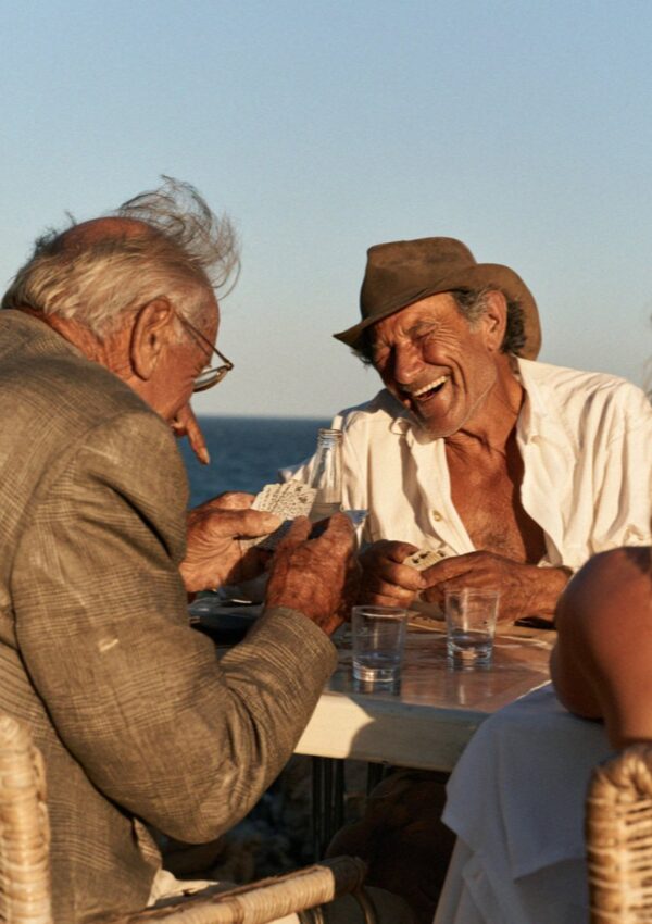 A card game on a terrace table above the sea on the Costa Smeralda in Sardinia