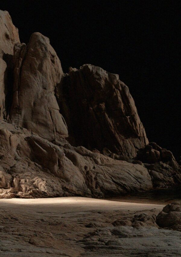 Bare granite and one lit patch of sand in the dark on the Costa Smeralda in Sardinia