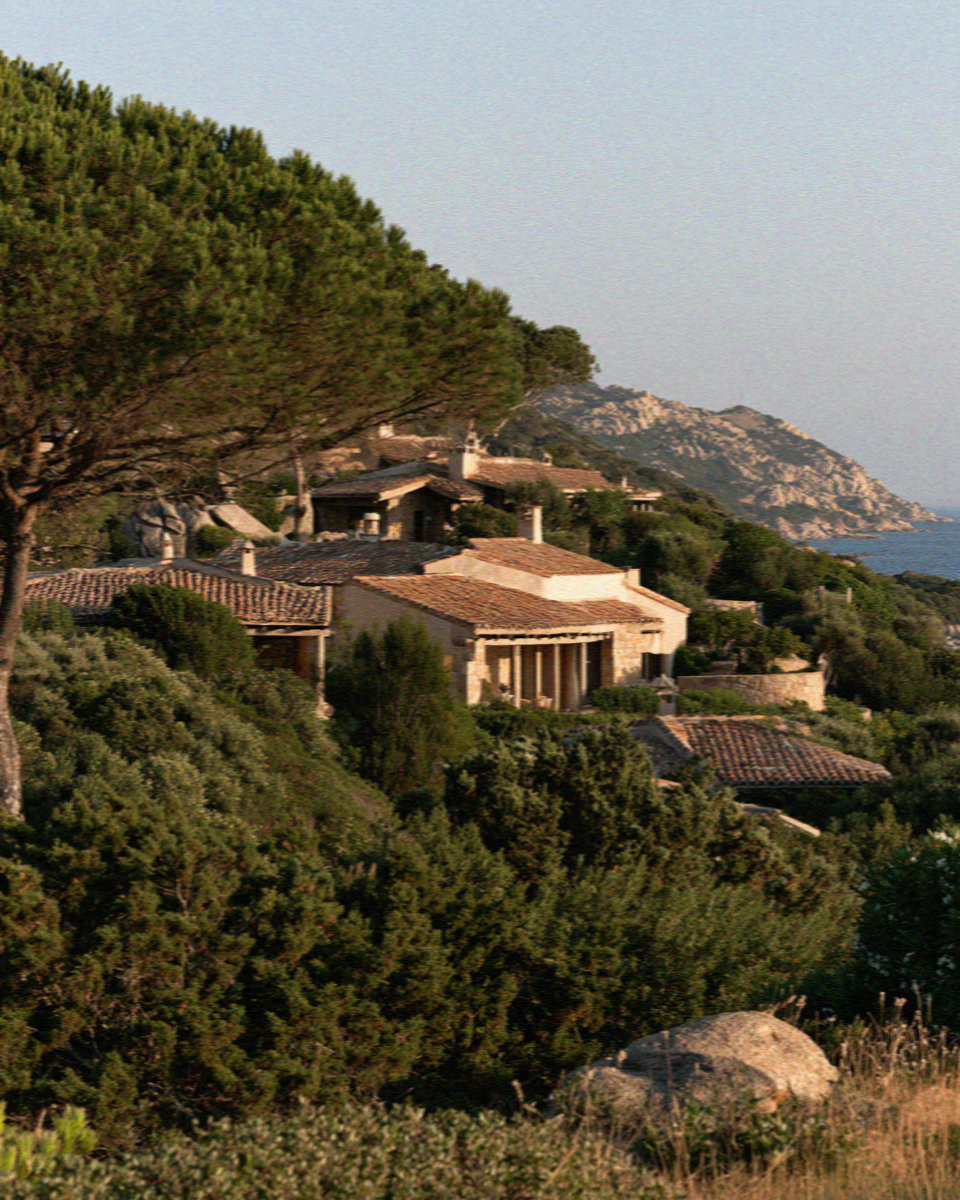 Low curved rooflines hidden in the scrub on the Costa Smeralda in Sardinia
