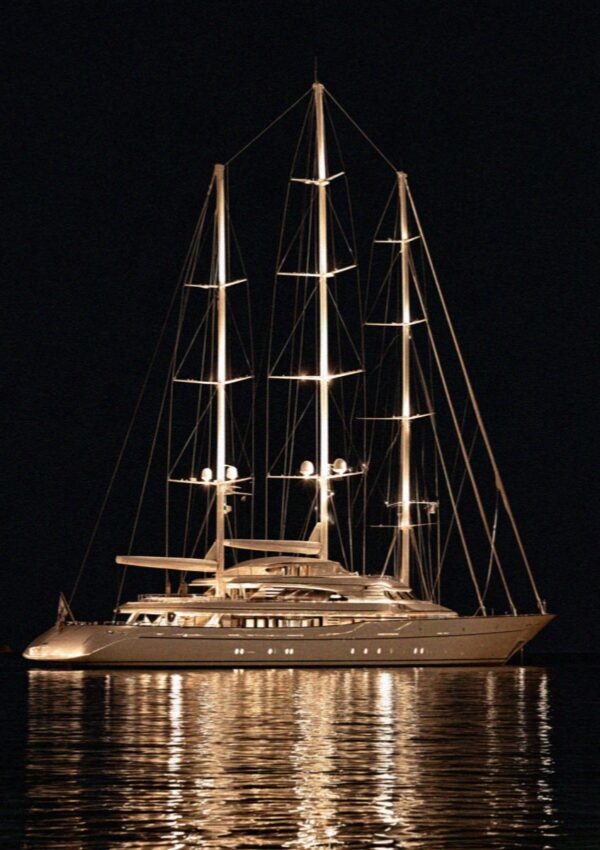 A lit yacht on flat black water at one in the morning on the Costa Smeralda in Sardinia