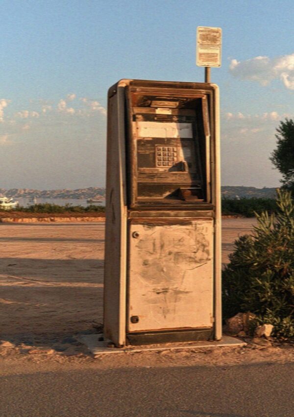 An old payphone on an empty road behind the Costa Smeralda in Sardinia